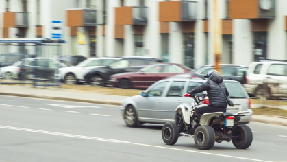 Someone riding an ATV in the street