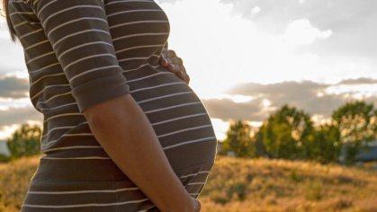 Pregnant woman holding her stomach