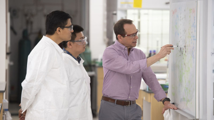 Professor Alan Goldman works with students Arun Shuda (SAS '20) and Xiaoguang Zhou (PhD candidate) 