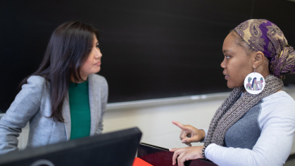 Assistant Professor Laura Cuesta-Rueda speaks with student Bianca Dossous during Social Welfare Policy and Services class in Conklin Hall 2019