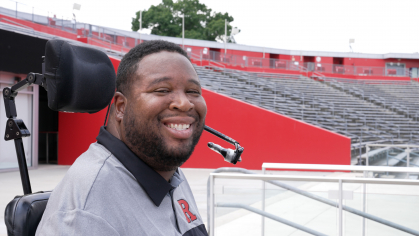 Rutgers alumnus Eric LeGrand smiles in the stands at SHI Stadium in Piscataway.