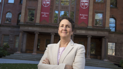 Senior Vice President and Chief Information Officer Michele Norin in front of Old Queens