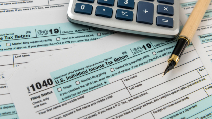 FORM 1040 taxes with calculator and pen 