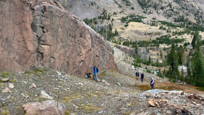 Mountain range with researchers at its base
