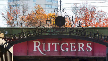 The main university entrance gate stands before the NJ Transit and Amtrack Northeast Corridor train line in New Brunswick.