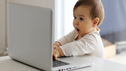 baby looks at laptop