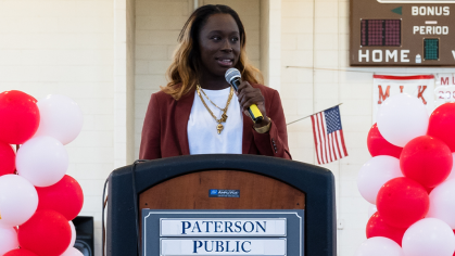 Essence Carson speaking at a podium