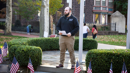 Jake Kopach standing at a veterans memorial