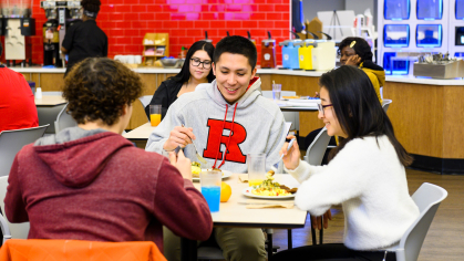 students chat while enjoying a meal at a Rutgers Camden dining Hall