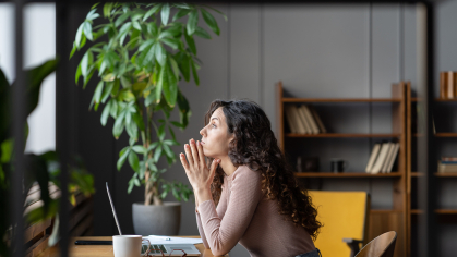 Woment sitting at her desk 
