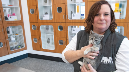 Laura Houston CCAS’90, GSC’94,  holding kitten