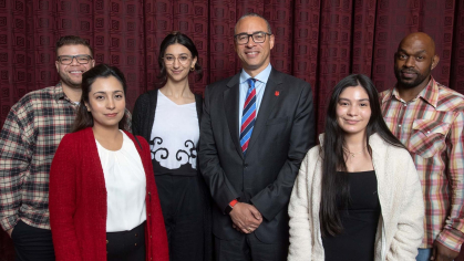 President Jonathan Holloway poses with Rutgers Scarlet Service students