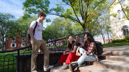 Rutgers students talk on steps near Bishop House on the College Avenue campus.