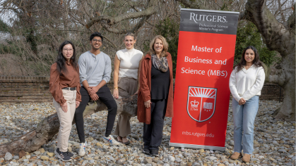Professor Kathleen Cashman-Walter pictured with her students and a Master of Business Science sign
