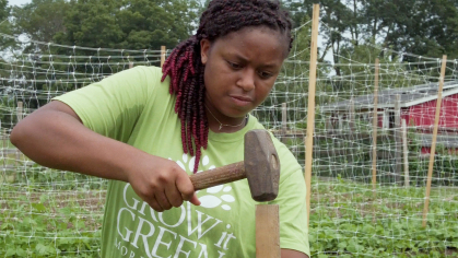 rutgers student working at Morristown urban farm