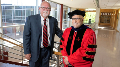 Professor Rich Haber, at left, with Jon Oliver in regalia that originally belonged to Bill Bauer.
