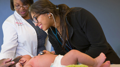 A nurse tending to a newborn baby