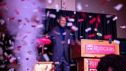 Confetti falling in room with chancellor Antonio Tillis at the lecture