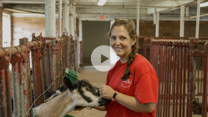 Rebecca Potosky with a Goat on the Rutgers Farm