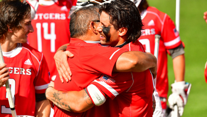 Uly Molina hugs a Rutgers Lacrosse player 