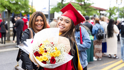 Grad holding flowers