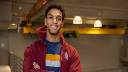 Rutgers sophomore poses for a photo arms crossed within the School of Engineering. 