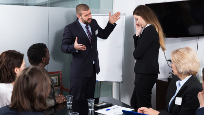 man and woman arguing during office presentation