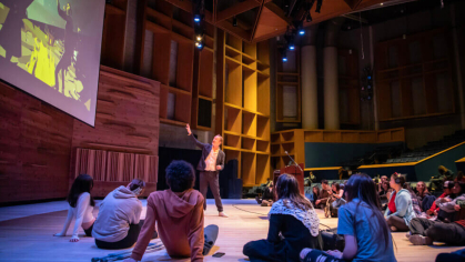 students sitting at a theater class