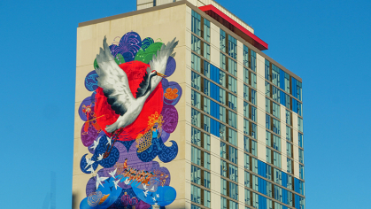 A building in Camden shows an elaborate mural that includes a stork