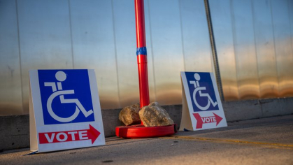 Signs showing drawings of wheelchairs directed people where to vote