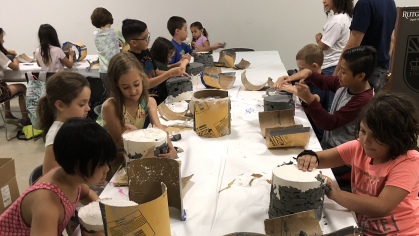 Children work with plaster casts during a Summer Art Camp class at the at the Zimmerli Art Museum.
