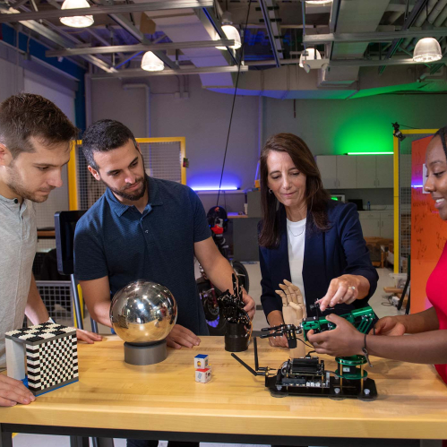 Electrical and Computer Engineering Professor Kristin Dana (c.) on set with SOE graduate students (l. to r.) Matthew Purri, Peri Akiva and Faith Johnson (SOE '19) in the robotics lab at Weeks Hall of Engineering during video taping of an episode of Faces and Voices of Rutgers