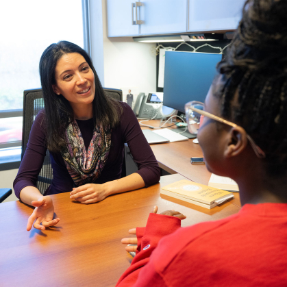 Andrea Rydel, assistant dean speaks to Jadaiah Lokko (SAS '26) in the office of Honors College