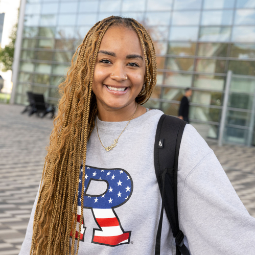 Taylor Winslow (SAS ’25) outside of the Rutgers Business School on the Livingston campus on a warm fall day.
