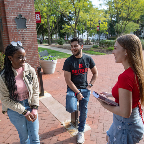 Rutgers students standing outside during a conversation