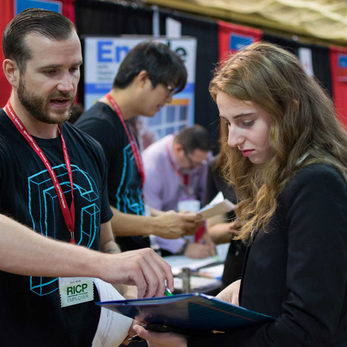 student receiving feedback on resume at career fair