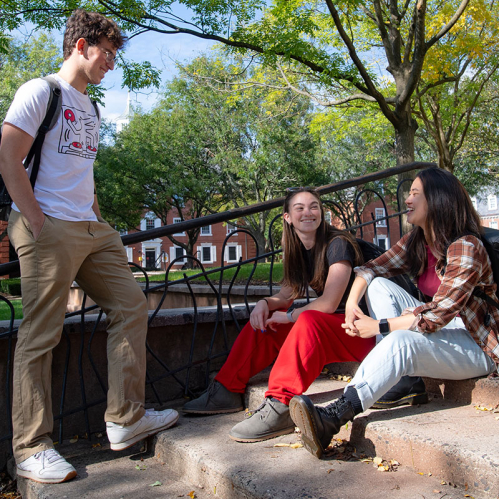 Rutgers students talk on steps near Bishop House on the College Avenue campus.