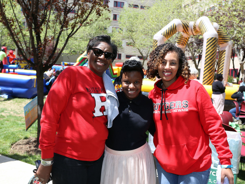 Three people wearing Rutgers apparel