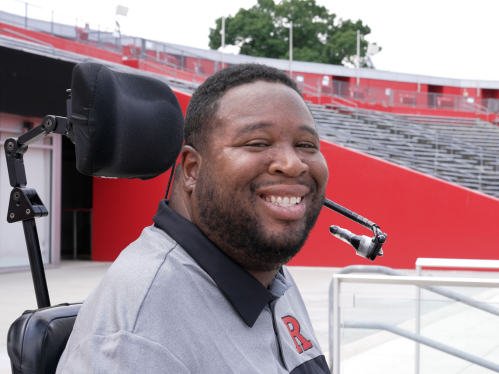 Rutgers alumnus Eric LeGrand smiles in the stands at SHI Stadium in Piscataway.