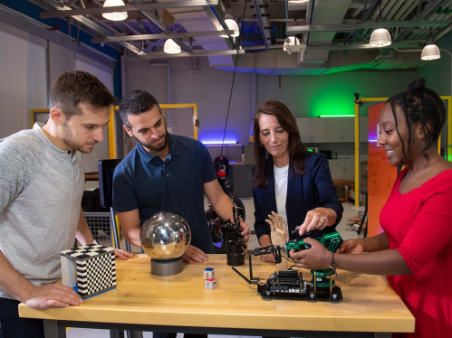  Electrical and Computer Engineering Professor Kristin Dana (c.) on set with SOE graduate students (l. to r.) Matthew Purri, Peri Akiva and Faith Johnson (SOE '19) in the robotics lab at Weeks Hall of Engineering during video taping of an episode of Faces and Voices of Rutgers