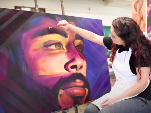 Camden College of Arts and Sciences fine arts student in the studio painting