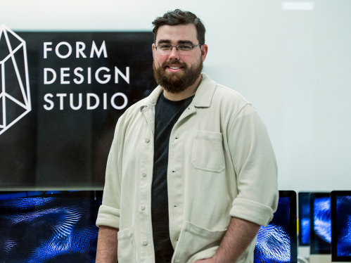 Rutgers–Newark student James Negri stands in the computer lab at the Form Design Studio, part of Express Newark
