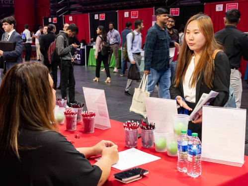 An attendee talks with a recruiter during the Fall 2023 Career and Internship Mega Fair at Rutgers University–New Brunswick.