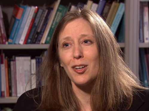 Jennifer Senick sitting in front of a bookshelf