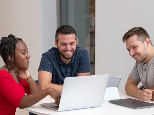 group of students working together at a laptop