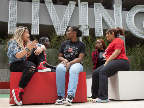 Rutgers students chatting outside the Honors Living-Learning Community in Newark. 