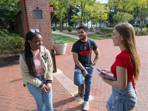 Rutgers students standing outside during a conversation