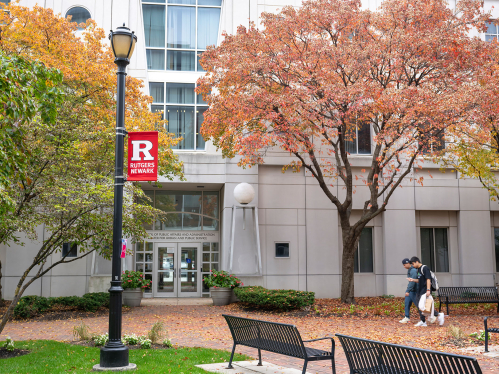 Students walk on plaza outside the School of Public Affairs and Administration, and Center for Urban and Public Service on the Newark campus in the fall.