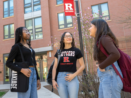 Rutgers students chat outside on the College Avenue campus