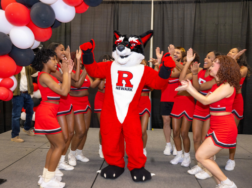 The Rutgers Newark Cheer team welcomes the mascot 